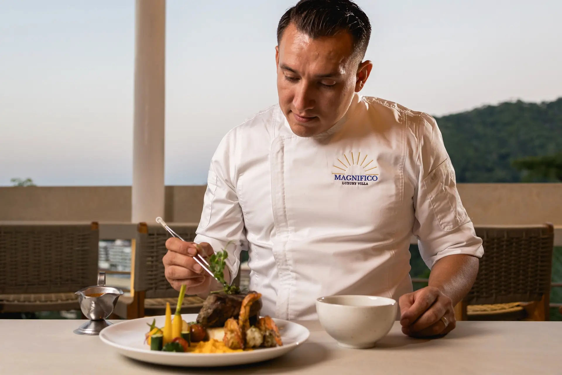 Villa Experience chef plating a course at Villa Magnifico, Puerto Vallarta