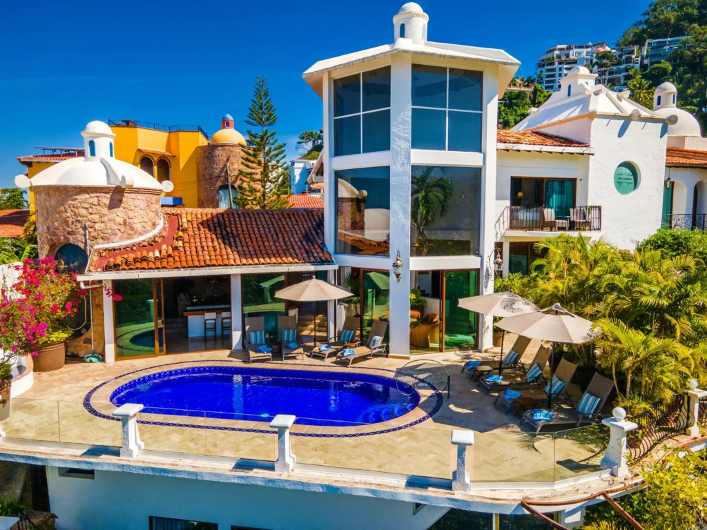 Casa Aventura white villa exterior and curved pool — Puerto Vallarta, Mexico