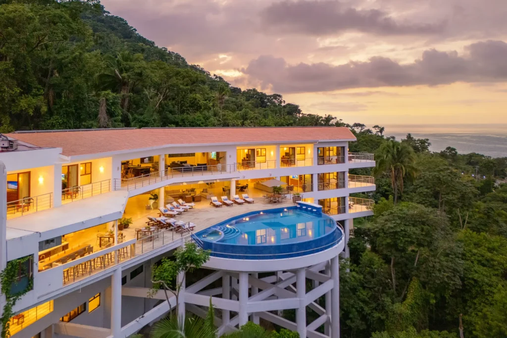 Villa Magnifico multi-level villa glowing above the round pool at sunset — Puerto Vallarta, Mexico