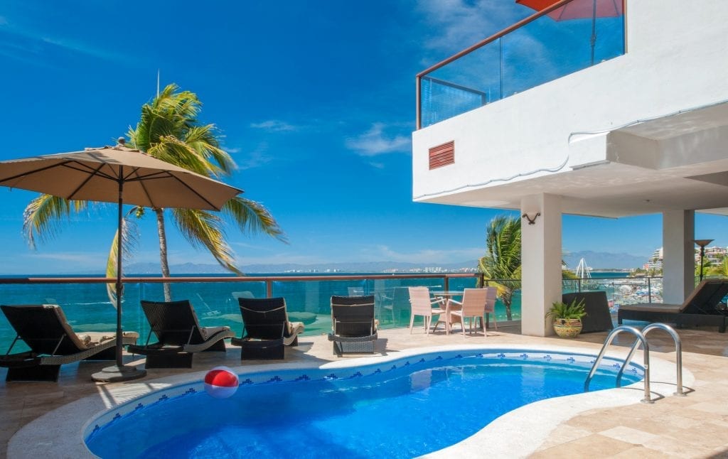 Vallarta Shores Sky Suite A outdoor pool and sun loungers with ocean view — Puerto Vallarta, Mexico