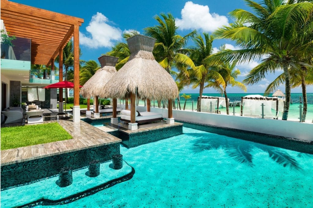 Villa Azul Esmeralda pool with palapa cabana and umbrellas by the villa — Puerto Morelos, Mexico