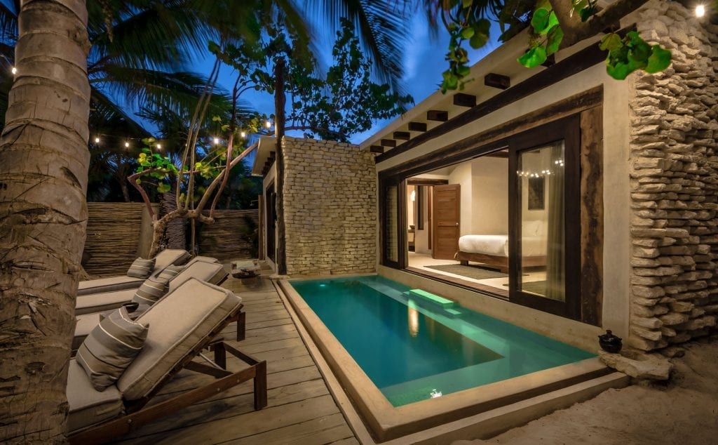 Casa Chukum string lights over the plunge at nightfall — Tulum, Mexico