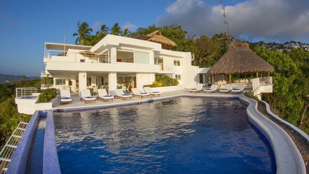 Casa Garbi white villa, swimming pool and thatched pavilion — Acapulco, Mexico