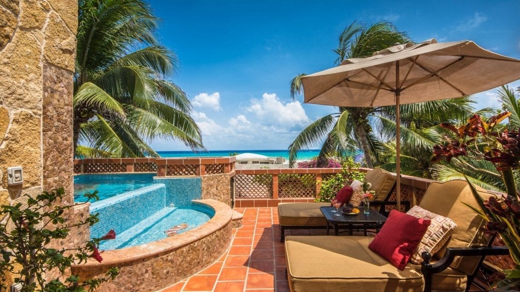 Casa Gigi poolside terrace with umbrella, loungers, and ocean view — Playa del Carmen, Mexico