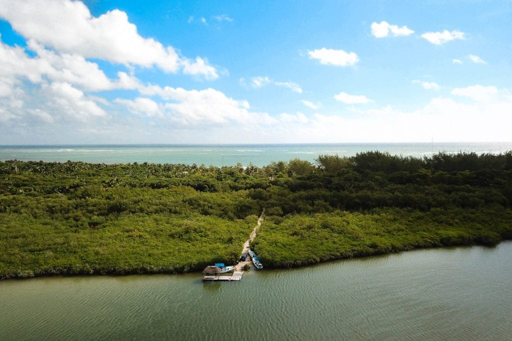 A small boat crossing a mangrove lagoon inside the Sian Ka'an reserve