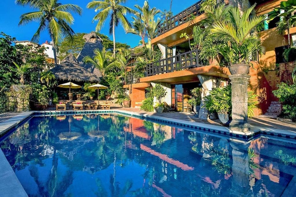 Casa Septiembre the pool reflecting the villa's stone facade — Puerto Vallarta, Mexico