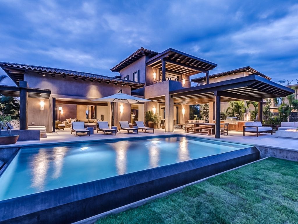 Villa Marlago pool lit at blue hour with covered terraces behind — Punta Mita Nayarit, Mexico