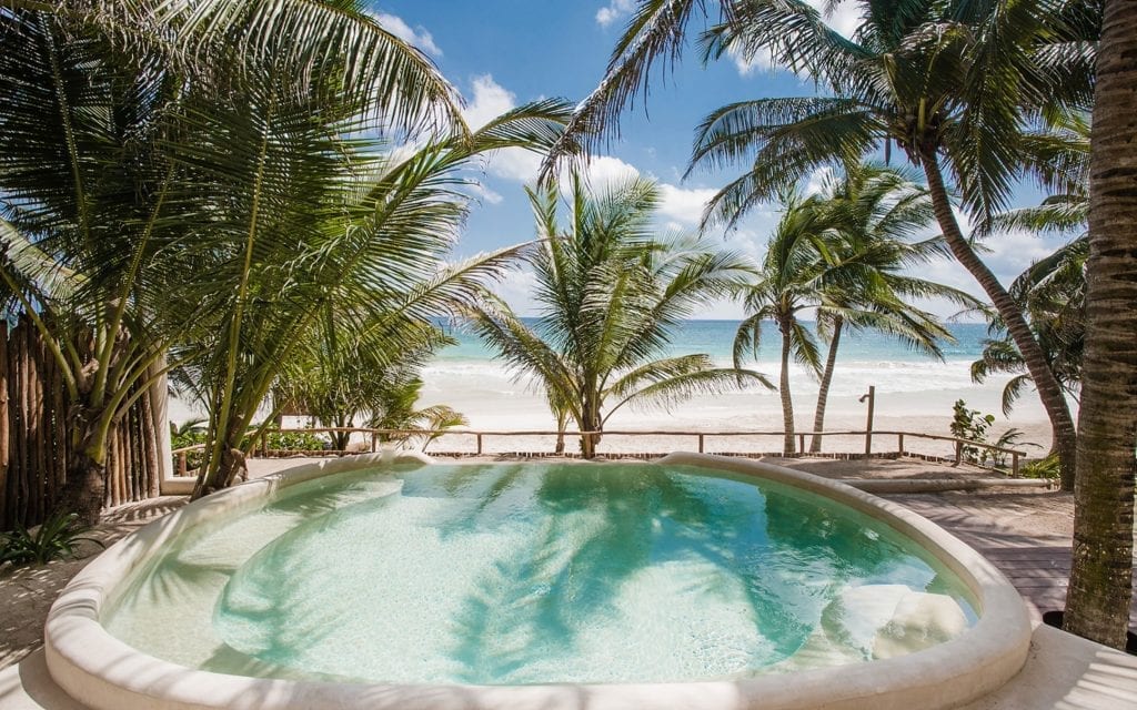 Zorba Cinco private pool with palms and the Caribbean beyond, Tulum