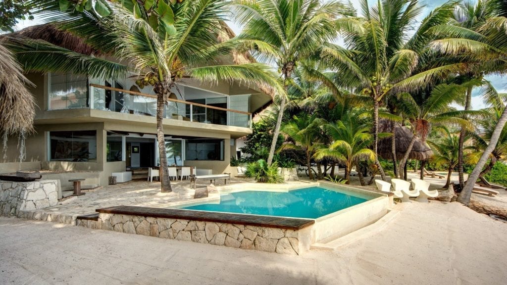 Villa Zacil Na pool and terrace enclosed by tall palms — Puerto Aventuras, Mexico