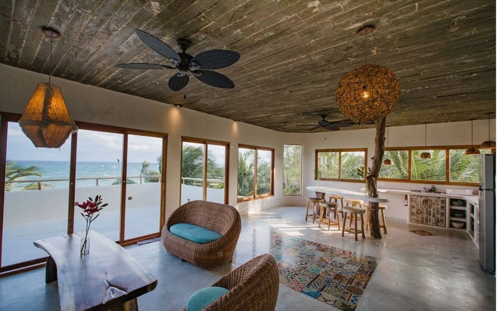 Zorba Penthouse living room and kitchen opening to the Caribbean view, Tulum
