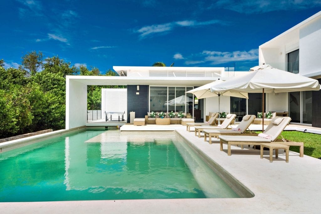 Casa Marazul pool with sun loungers and the villa's covered terrace — Cancun, Mexico