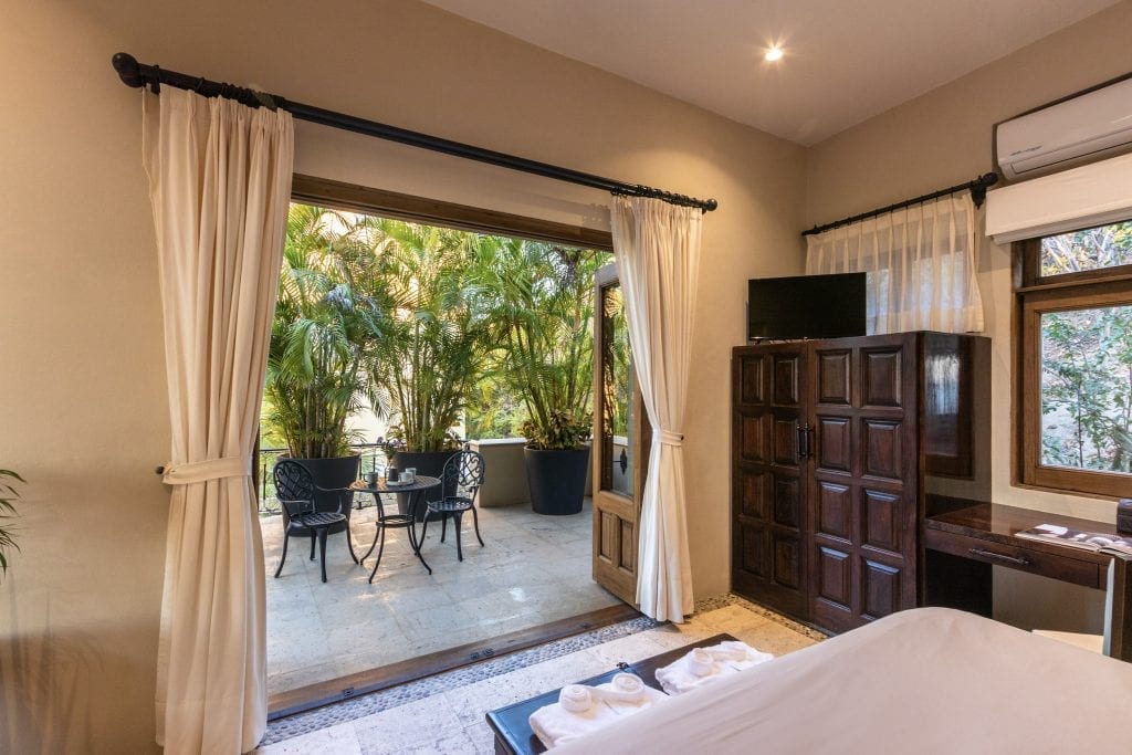 Indoor and outdoor lounges arranged towards the sea at Villa Escondida