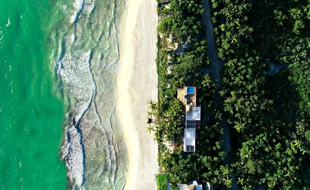 Villa Destiny sea foam combing the sand from above — Tulum, Mexico