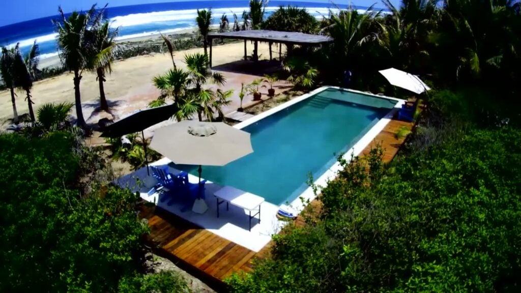 Suite El Ranchito – Los Guajes pool, wooden deck and palms seen from above — Puerto Escondido, Mexico