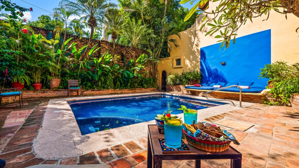 Villa Las Puertas pool with a tiled water feature and drinks on a brick deck — Puerto Vallarta, Mexico