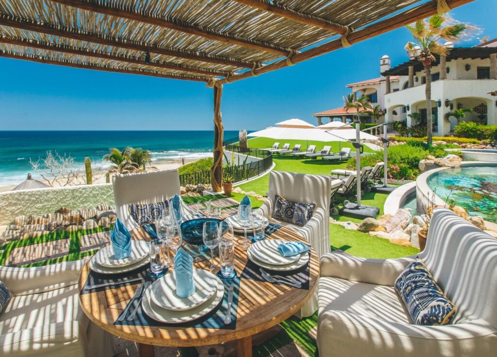 Casa Bellamar covered terrace with set dining table and pool view — Los Cabos, Mexico