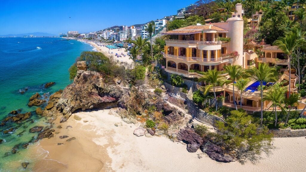 Villa Estrella Mar Vallarta aerial view of a cliffside villa between beach and city — Puerto Vallarta, Mexico