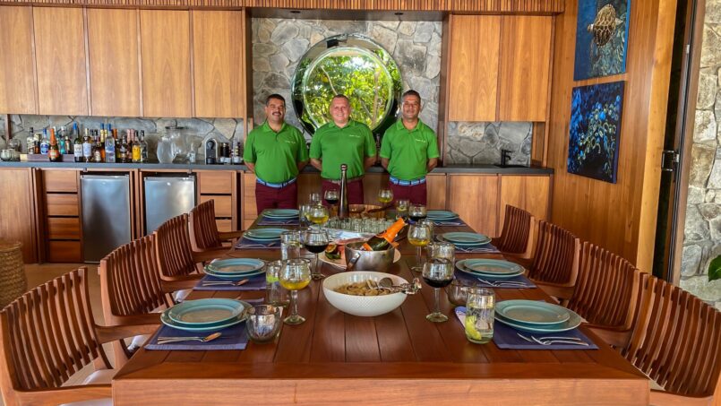 Professional villa staff standing at beautifully set dinner table in luxury villa in Puerto Vallarta