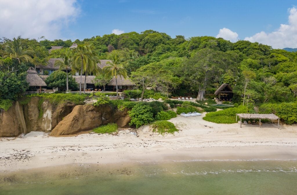 Villa Amanecer aerial view from the water of the tree-covered villa and beach — Punta Mita Nayarit, Mexico