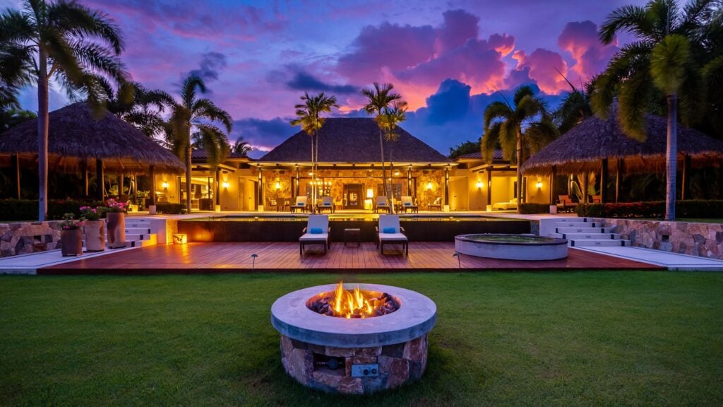 Casa Belleza round lawn fire pit with the house illuminated at twilight — Punta Mita Nayarit, Mexico