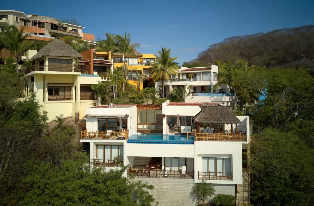 Casa Habana side aerial view of the hillside villa and pool among trees — Punta Mita Nayarit, Mexico