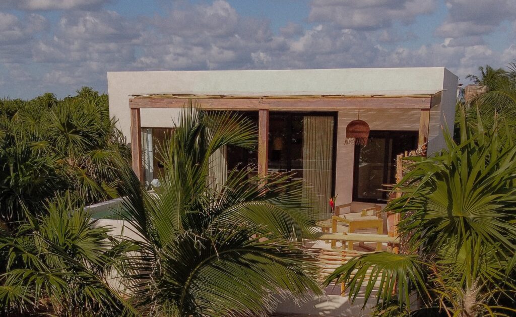 Casa Chechen Penthouse elevated exterior surrounded by palm trees — Tulum, Mexico