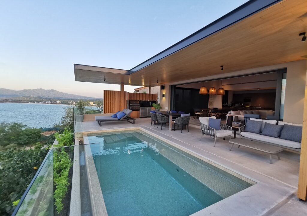 Villa Iyari B6 pool terrace at dusk overlooking the bay and coastal hills — Punta Mita Nayarit, Mexico