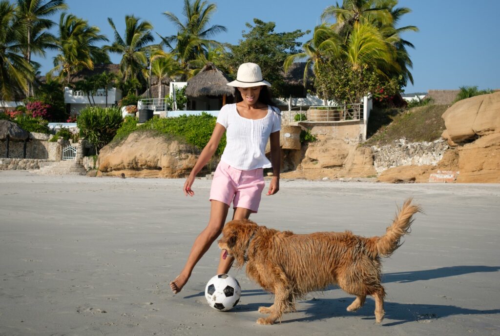 Vacationer playing with his dog at a pet-friendly rental in Mexico.