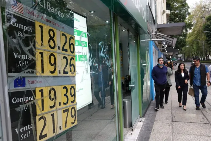 A bank window in Mexico displaying the exchange rates of the dollar and euro to Mexican pesos.