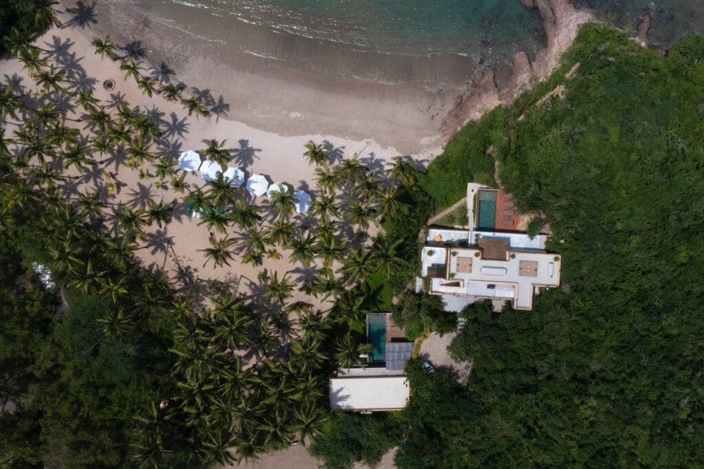Casa Tauro high aerial view of the villa among trees beside the beach — Costa Careyes, Mexico