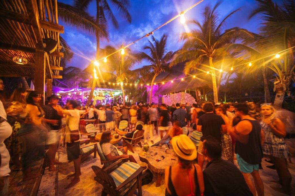 Audience enjoying a nighttime music festival in Tulum, Mexico