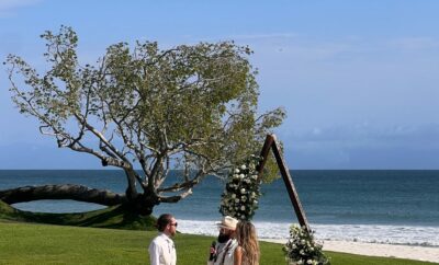 A beautiful wedding ceremony on the beach in front of Casa Escondida, Punta Mita, with the couple exchanging vows against the backdrop of the sparkling ocean.
