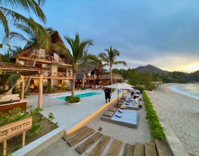 A panoramic evening view of Villa Mixto, a leading Puerto Vallarta event venue and wedding villa, set against the beautiful Quimixto Beach.