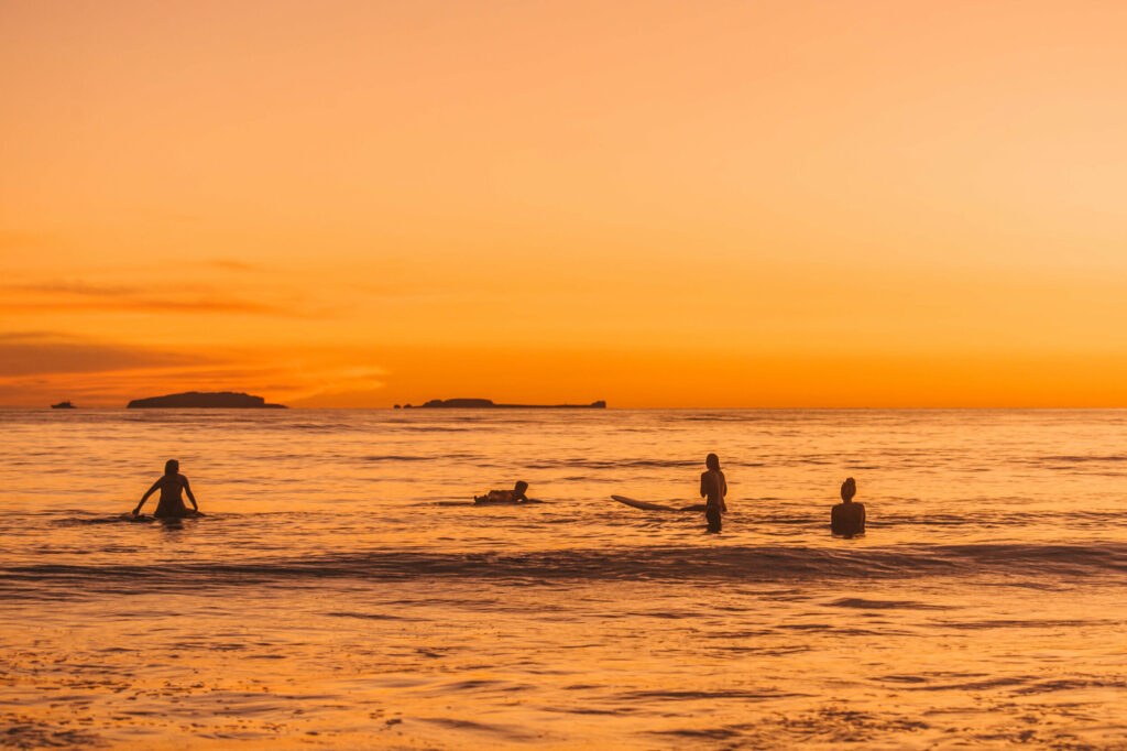 Surfers enjoying the waves at sunset at Ranchos Estates