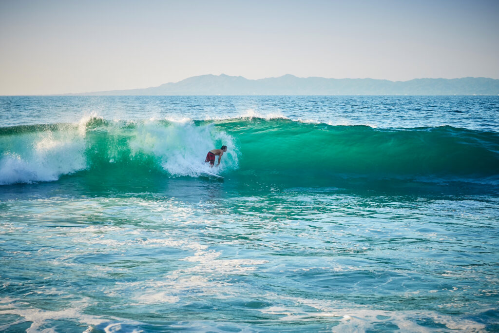 A surfer enjoying a wave at a surf spot in Quimixto.