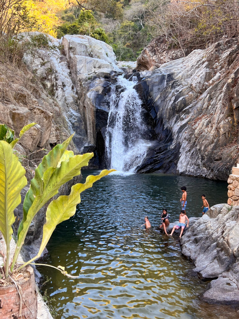 People bathing in the serene waters of Quimixto waterfall, Mexico.