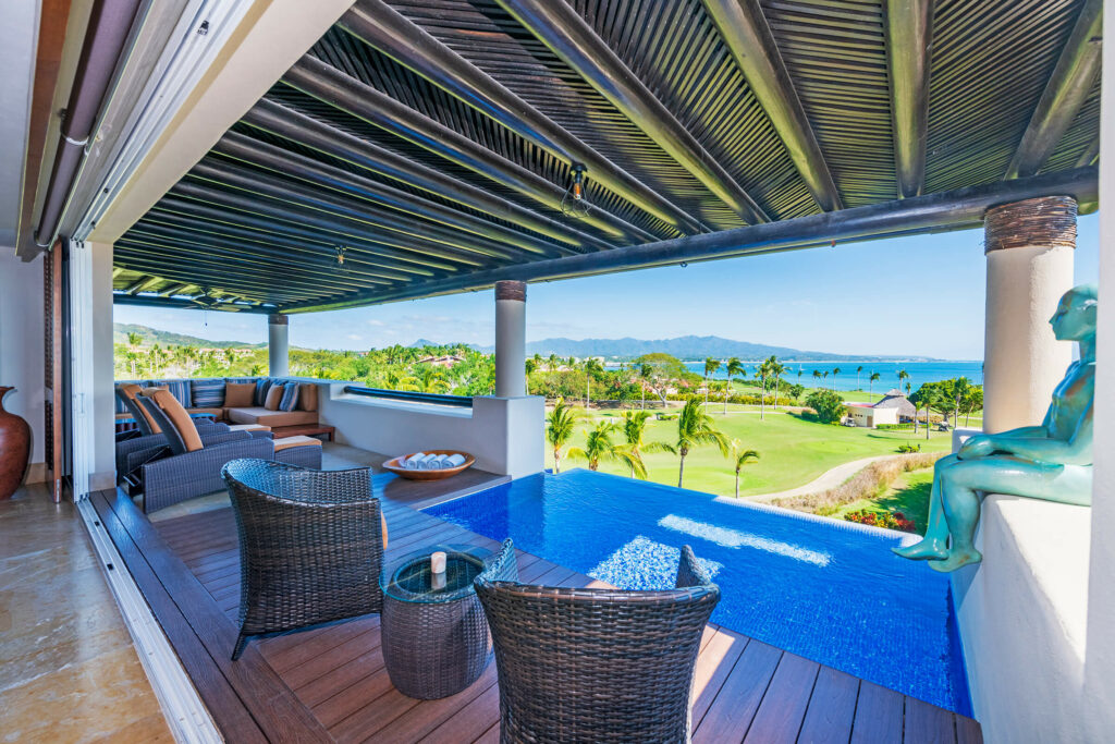 PH Vista el Encanto terrace seating beside a small pool with a golf course view — Punta Mita Nayarit, Mexico