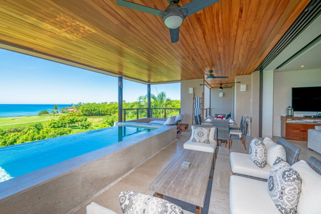 Condo Aries long terrace pool beside covered seating and an ocean view — Punta Mita Nayarit, Mexico