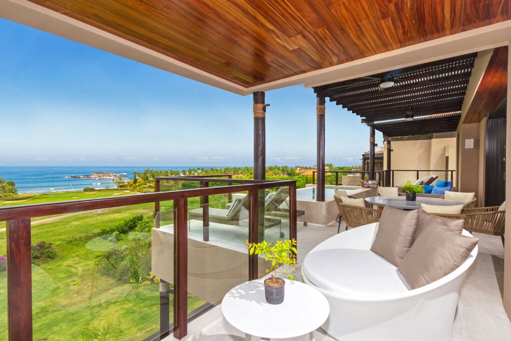 Condo Dalia corner terrace with a round white chair, dining table, and ocean view — Punta Mita Nayarit, Mexico