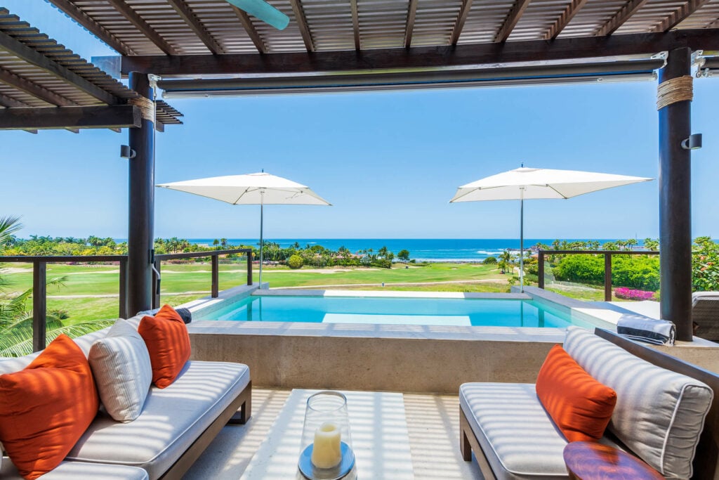 Condo Piscis covered terrace sofas beside a pool with ocean view — Punta Mita Nayarit, Mexico