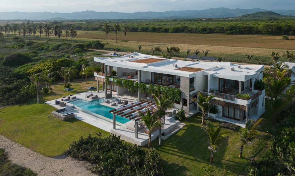 Villa Niku aerial of the villa complex, pool, and palm gardens — Puerto Escondido, Mexico