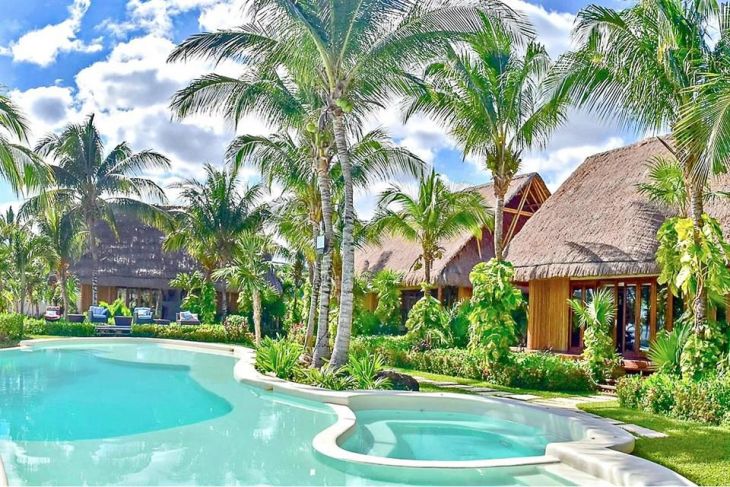 Aerial view of Villa Chakté Cancún with its luxurious design overlooking the azure Caribbean Sea.