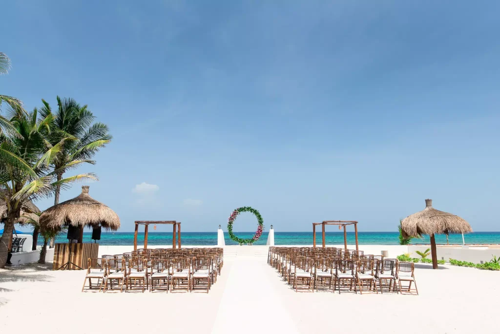 A romantic wedding ceremony in progress at the beachfront 'Hacienda del Secreto' in Playa del Secreto.