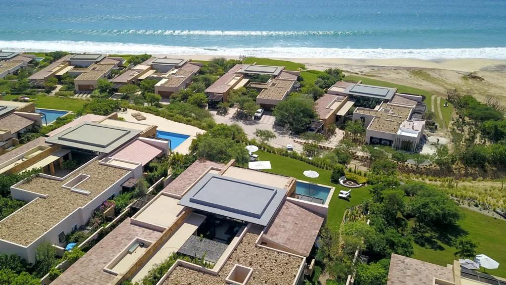 Elevated view of the Ritz-Carlton Reserve Residence community, focusing on the opulence of the West Enclave and its 27 grand villas surrounded by lush landscapes