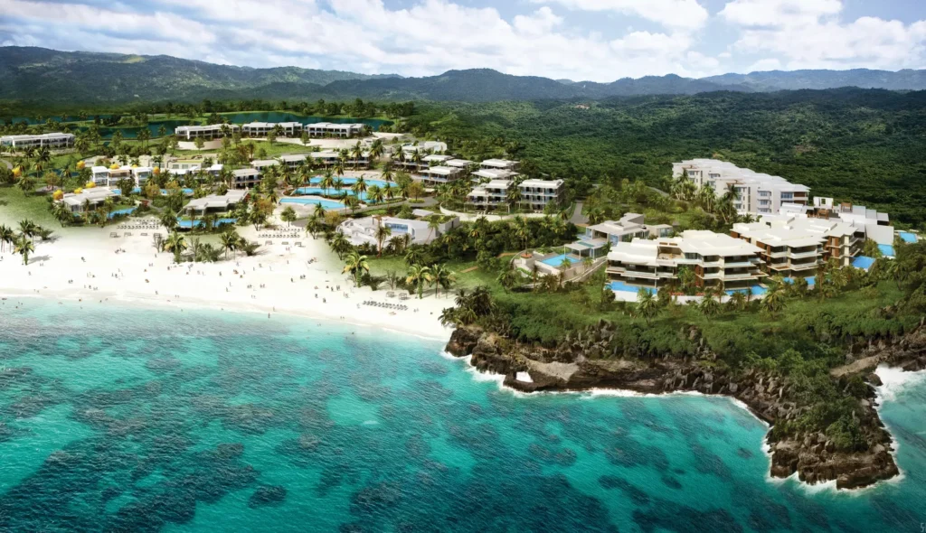Aerial view of Auberge Resort's Susurros de Corazón, showcasing the luxurious residences and villas nestled between the lush landscape and the ocean.