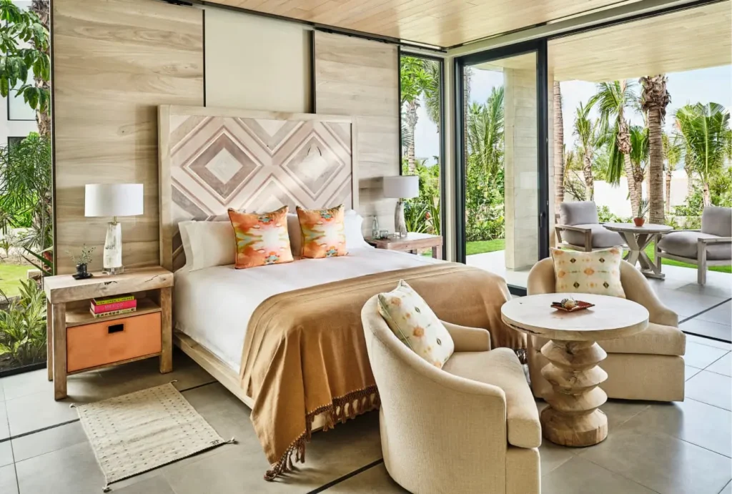 Inside a modern, stylish bedroom of the luxury villas at Susurros de Corazón, showcasing elegant design with ocean views.