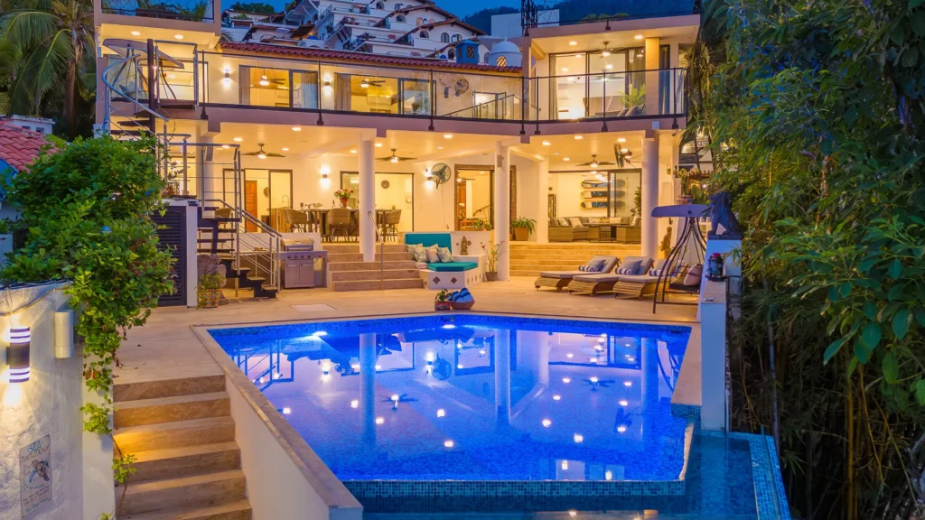 Casa Morada villa exterior illuminated at dusk with the pool — Puerto Vallarta, Mexico