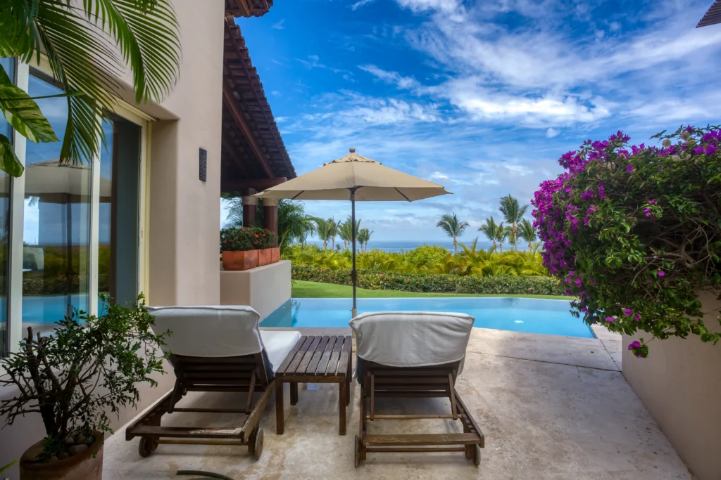 Villa Pelicanos - Four Seasons Private Villa two loungers under an umbrella beside the pool — Punta Mita Nayarit, Mexico