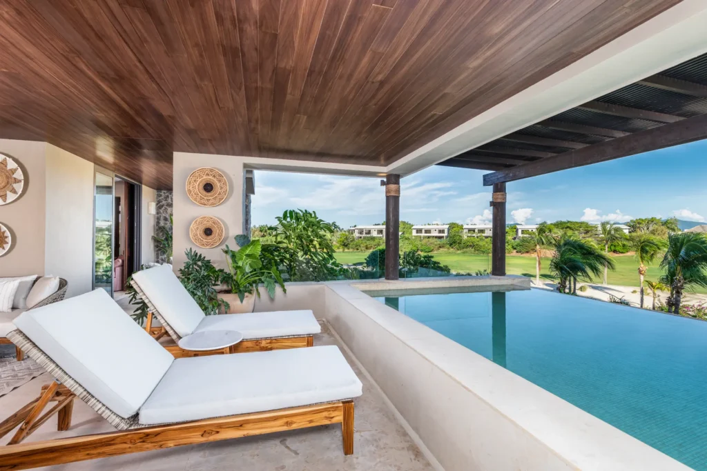 Tau Residences, Tower 5 two white loungers beside the pool beneath a wood ceiling — Punta Mita Nayarit, Mexico