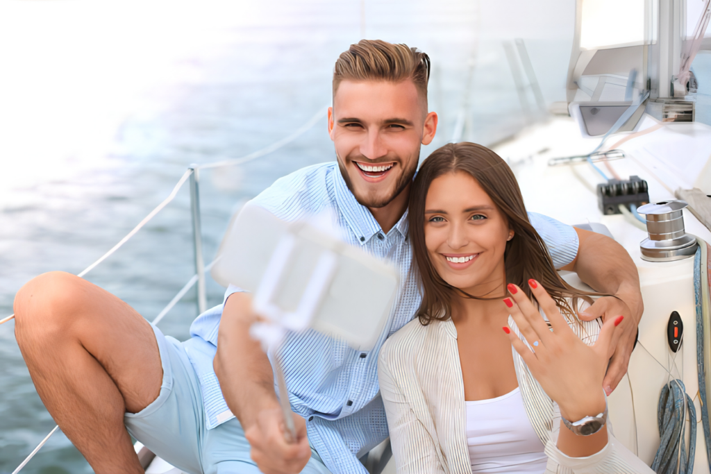 A couple taking a selfie on a yacht in Puerto Vallarta after a marriage proposal.